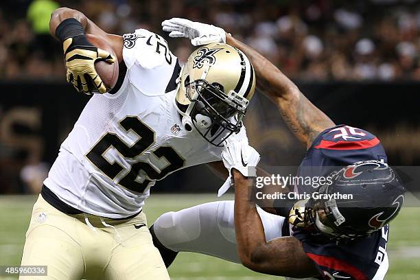 Spiller of the New Orleans Saints is tackled by Eddie Pleasant of the Houston Texans at the Mercedes-Benz Superdome on August 30, 2015 in New...