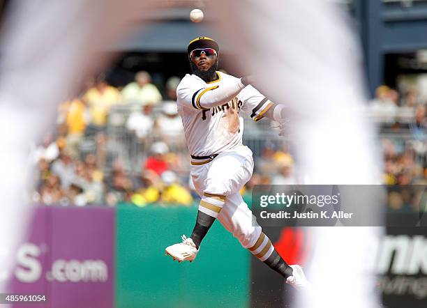 Josh Harrison of the Pittsburgh Pirates makes a throw to first base in the sixth inning during the game against the Colorado Rockies at PNC Park on...