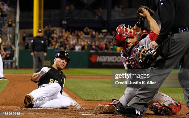 Russell Martin of the Pittsburgh Pirates scores on a RBI walk off single in the ninth inning Devin Mesoraco of the Cincinnati Reds during the game at...