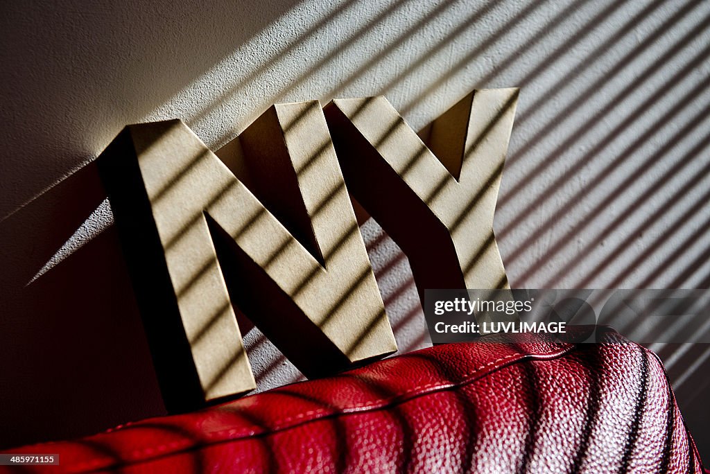 Letters N Y on couch