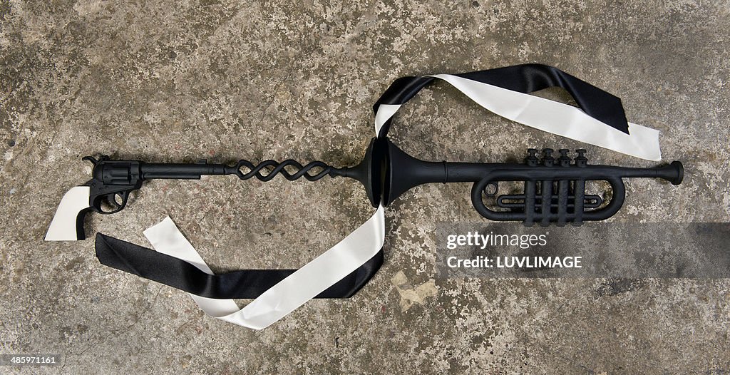 Toy revolver with toy trumpet and ribbons