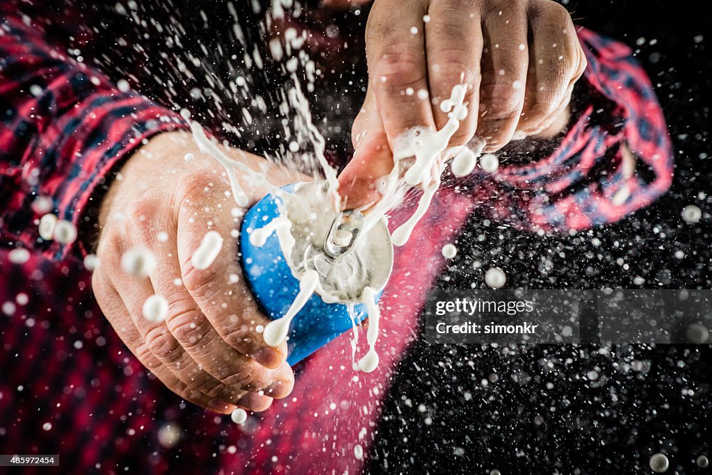 Frothy foam splashing out of a tin can