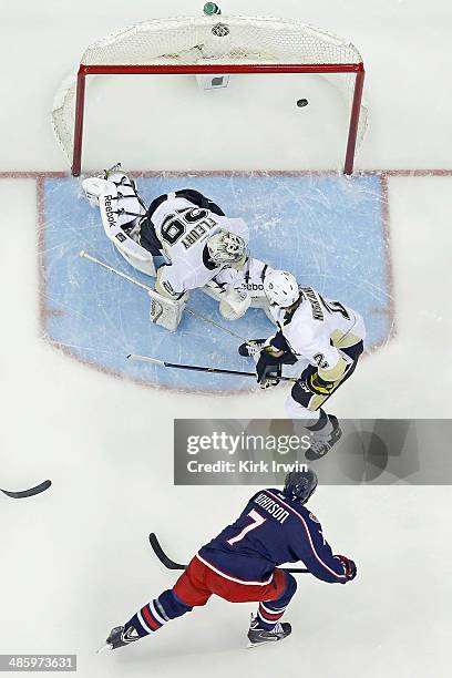Jack Johnson of the Columbus Blue Jackets shoots the puck past Matt Niskanen and Marc-Andre Fleury of the Pittsburgh Penguins during the first period...
