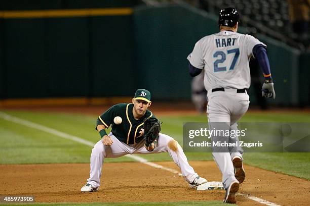 Daric Barton of the Oakland Athletics fields during the game against the Seattle Mariners at O.co Coliseum on April 3, 2014 in Oakland, California....