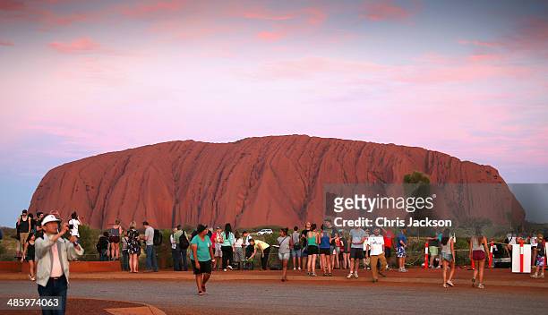 Tourists take photographs at sunset a Uluru ahead of a visit by Prince William, Duke of Cambridge and Catherine, Duchess of Cambridge on April 21,...