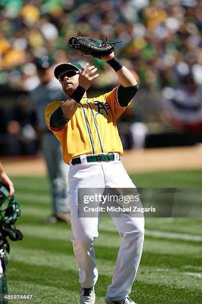 Daric Barton of the Oakland Athletics catches a pop-up during the game against the Seattle Mariners at O.co Coliseum on April 5, 2014 in Oakland,...