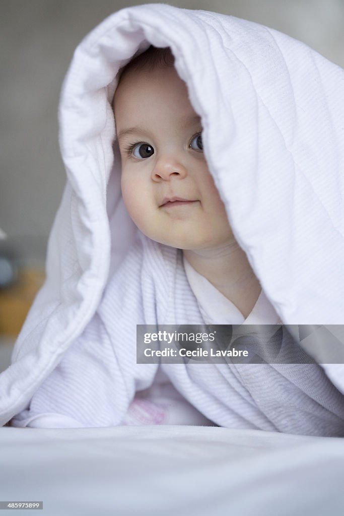 Baby portrait from under cover