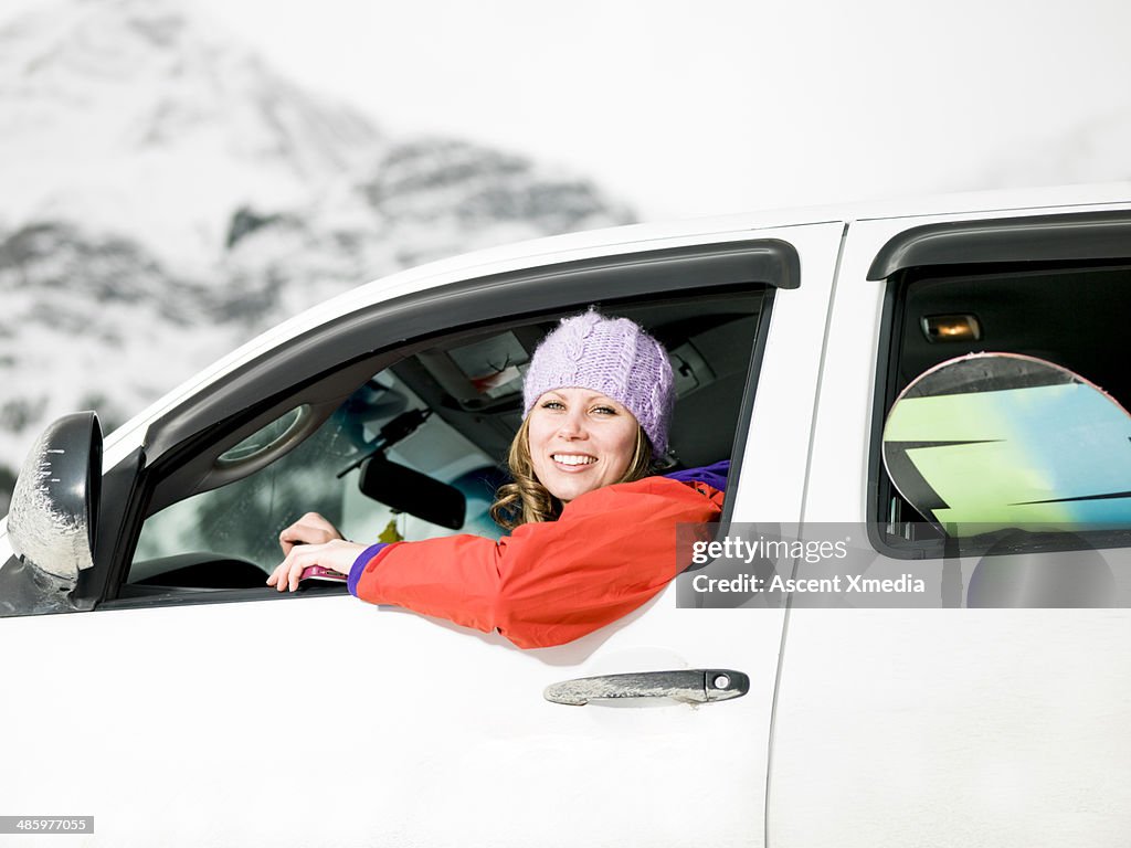 Portrait of snowboarder driving pick-up truck