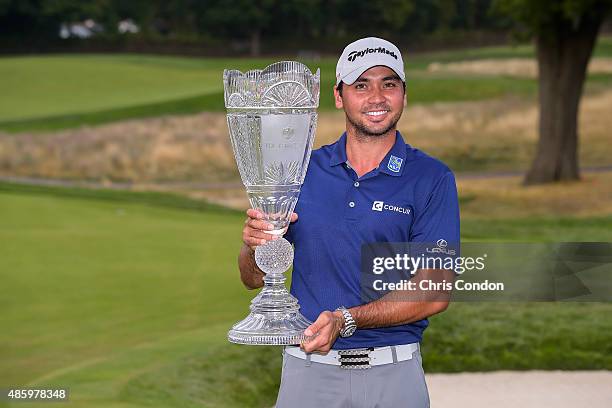 Jason Day of Australia poses with the championship trophy following his six-stroke victory in the final round of The Barclays at Plainfield Country...