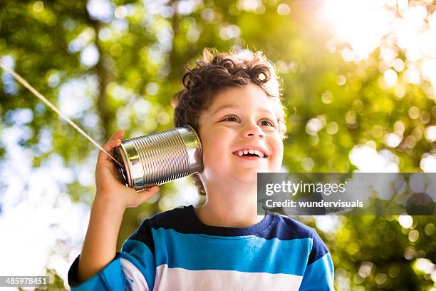 child communication concept - listening tin can stock pictures, royalty-free photos & images