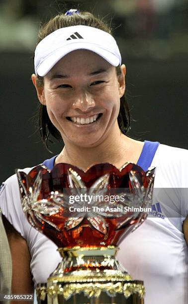 Kimiko Date-Krumm poses for photographs with the trophy after winning the Ladies Singles during day seven of the Dunlop World Challenge at Sky Hall...
