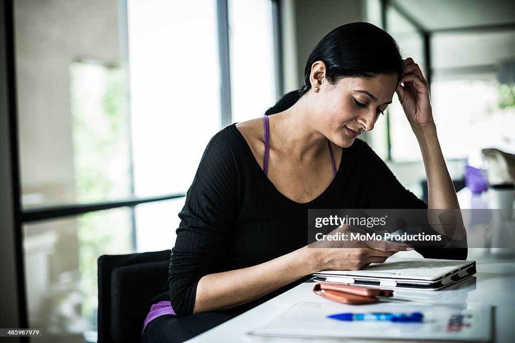 Woman using smartphone at home
