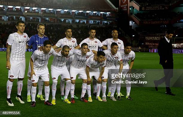 Mauricio Pellegrino, coach of Independiente, walks the field as his players pose before a match between Independiente and Estudiantes as part of 22nd...