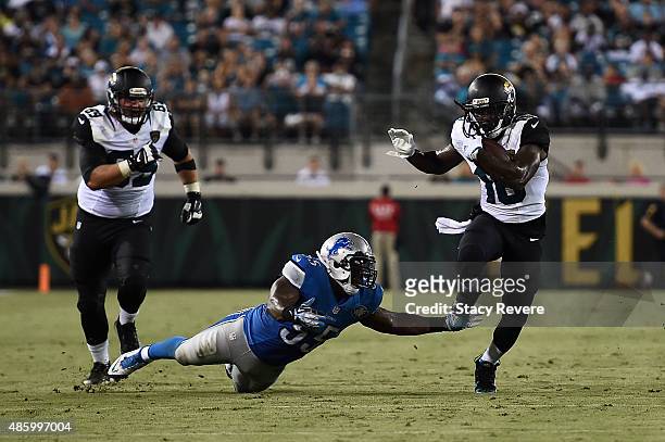Denard Robinson of the Jacksonville Jaguars avoids a tackle by Stephen Tulloch of the Detroit Lions during a preseason game at EverBank Field on...