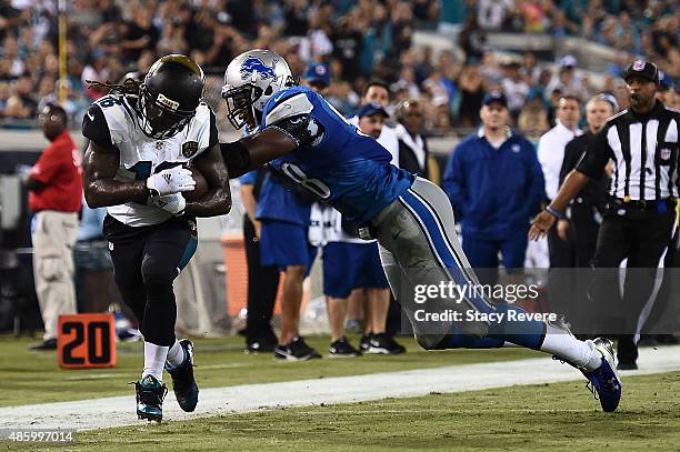 Lance Moore of the Detroit Lions is brought down by Devin Taylor of the Detroit Lions during a preseason game at EverBank Field on August 28, 2015 in...