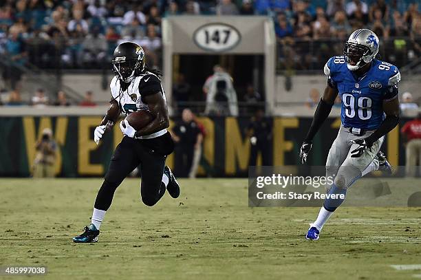 Denard Robinson of the Jacksonville Jaguars is pursued by Gabe Wright of the Detroit Lions during a preseason game at EverBank Field on August 28,...