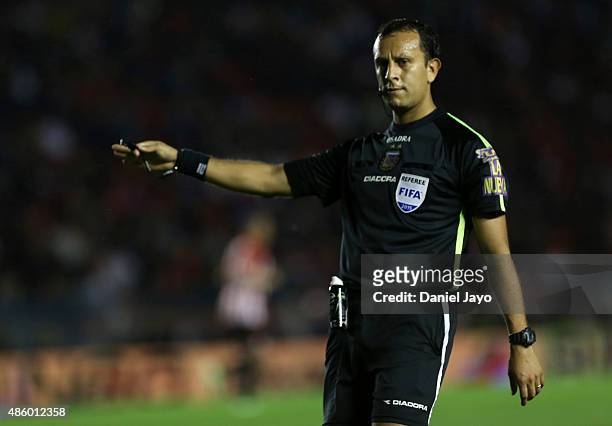 Referee Dario Herrera gestures during a match between Independiente and Estudiantes as part of 22nd round of Torneo Primera Division 2015 at...