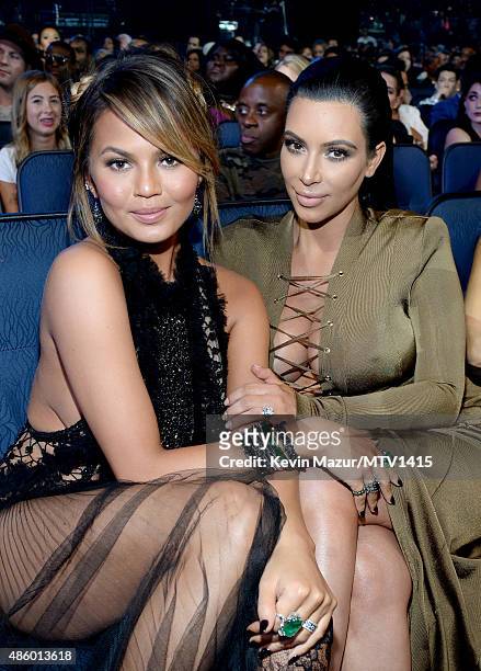 Chrissy Teigen and Kim Kardashian West attend the 2015 MTV Video Music Awards at Microsoft Theater on August 30, 2015 in Los Angeles, California.