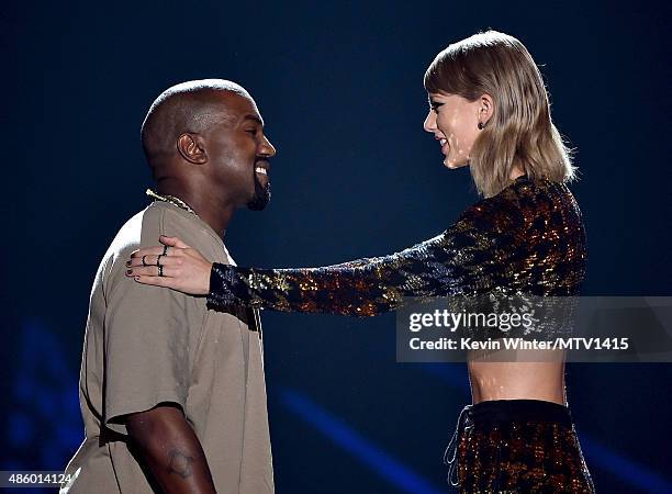 Recording artist Kanye West accepts the Video Vanguard Award from recording artist Taylor Swift onstage during the 2015 MTV Video Music Awards at...