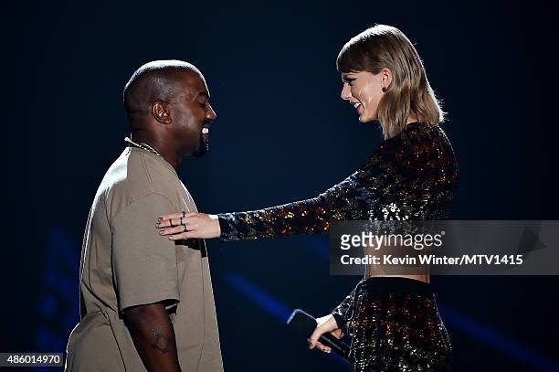 Recording artist Kanye West accepts the Video Vanguard Award from recording artist Taylor Swift onstage during the 2015 MTV Video Music Awards at...