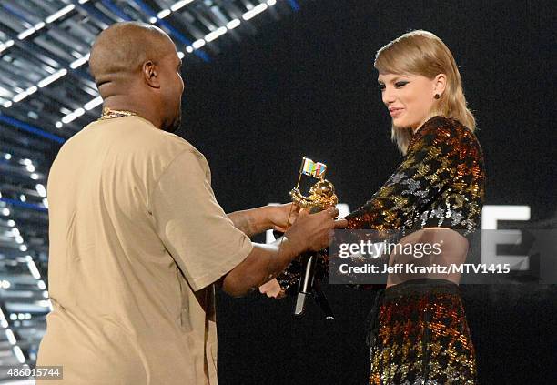 Recording artist Kanye West accepts the Michael Jackson Video Vanguard Award from Taylor Swift onstage during the 2015 MTV Video Music Awards at...