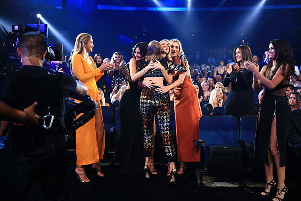 Models Gigi Hadid, Lily Aldridge, Martha Hunt, Karlie Kloss congratulate recording artist Taylor Swift as actress/singer Selena Gomez applauds during...