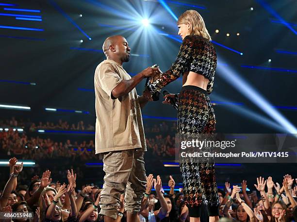 Recording artist Kanye West accepts the Vanguard Award from recording artist Taylor Swift onstage during the 2015 MTV Video Music Awards at Microsoft...