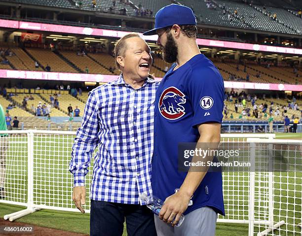 Starting pitcher Jake Arrieta of the Chicago Cubsis greeted by agent Scott Boras after pitching a no hitter against the Los Angeles Dodgers at Dodger...