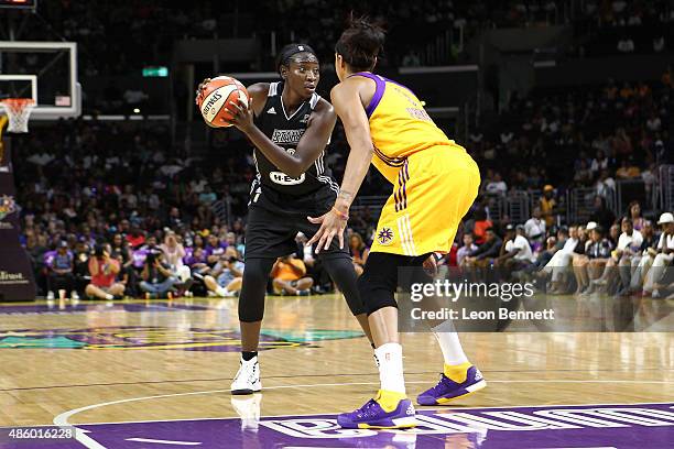 Sophia Young-Malcolm of the San Antonio Stars handle the ball against Candace Parker of the Los Angeles Sparks during a WNBA game on August 30, 2015...