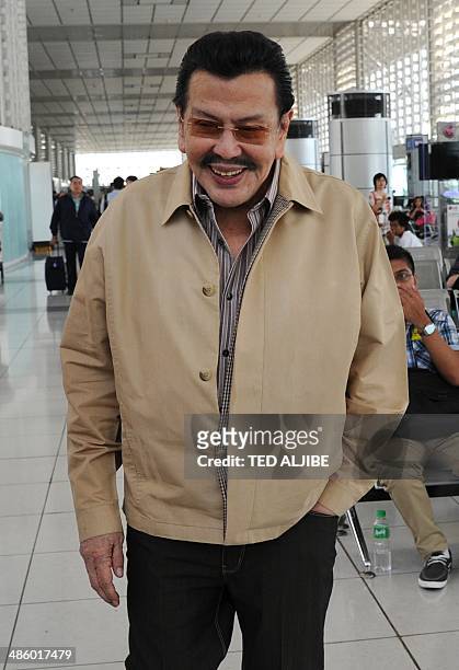 Former Philippine president and now mayor, Joseph Estrada, arrives at the departure area of the international airport in Manila on April 22 en route...