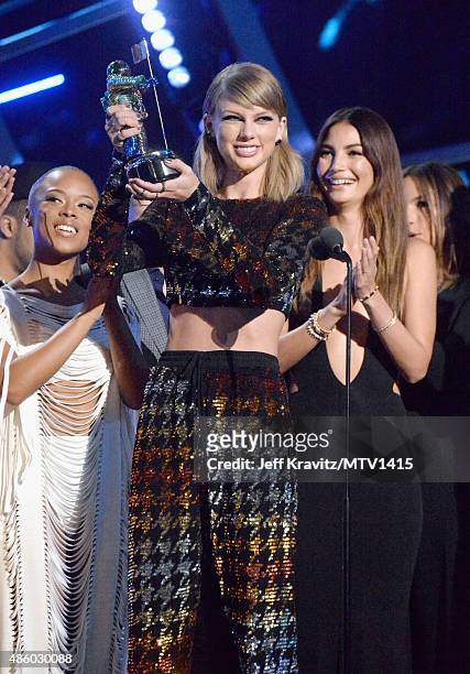 Recording artist Taylor Swift accepts the Video of the Year award for "Bad Blood" onstage with models Serayah and Lily Aldridge during the 2015 MTV...
