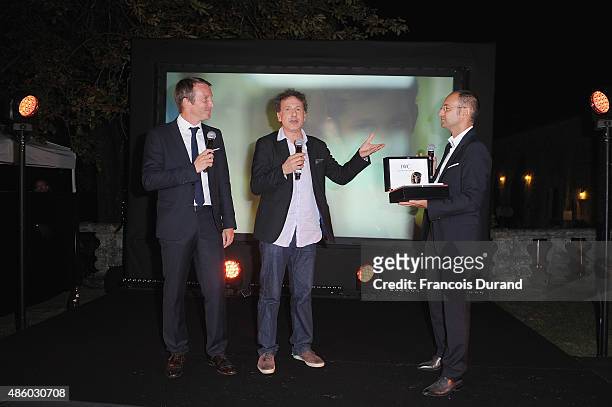 Stephane Rotenberg , Emmanuel Finkiel is awared a IWC Schaffhausen watch by Arnaud Miara on stage during the closing dinner hosted by IWC during...