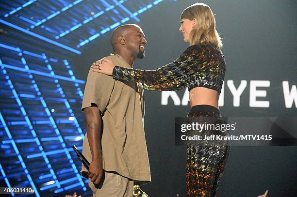 Recording artist Kanye West accepts the Michael Jackson Video Vanguard Award from Taylor Swift onstage during the 2015 MTV Video Music Awards at...