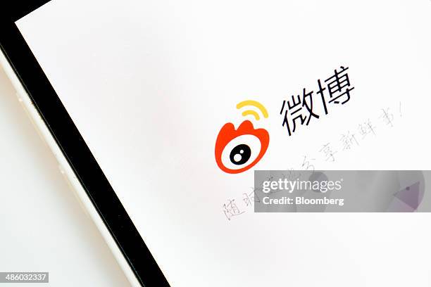 Loading page for Sina Corp.'s Sina Weibo microblogging service app is displayed on an Apple Inc. IPhone 5s in an arranged photograph in Hong Kong,...