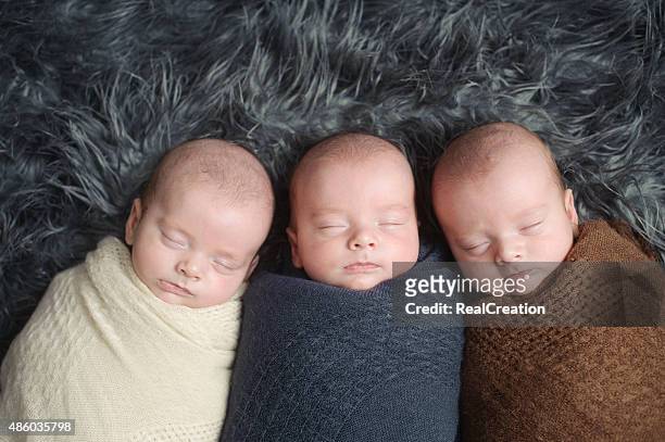 identical triplet brothers - triplets stock pictures, royalty-free photos & images