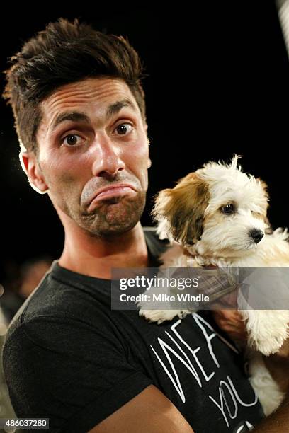 Nev Schulman poses with adoptable puppies from The Shelter Pet Project during the 2015 MTV Video Music Awards at Microsoft Theater on August 30, 2015...