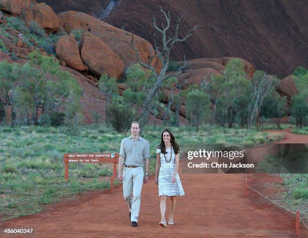 Catherine, Duchess of Cambridge and Prince William, Duke of Cambridge walk around the base of Uluru on April 22, 2014 in Ayers Rock, Australia. The...