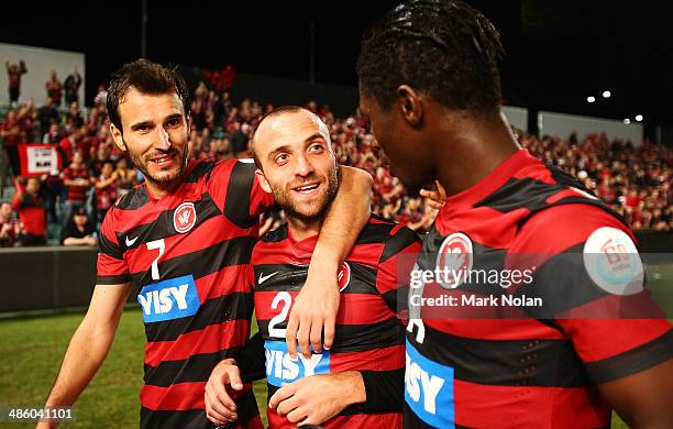 Labinot Haliti, Jason Trifiro, and Kwabena Appiah of the Wanderers celebrate winning the AFC Asian Champions League match between the Western Sydney...