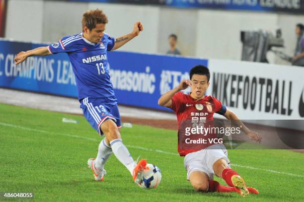 Yuzo Kobayashi of Yokohama F. Marinos competes for a ball against Sun Xiang of Guangzhou Evergrande during the AFC Asian Champions League match...