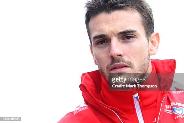 Jules Bianchi of France and Marussia walks across the paddock prior to the Chinese Formula One Grand Prix at the Shanghai International Circuit on...