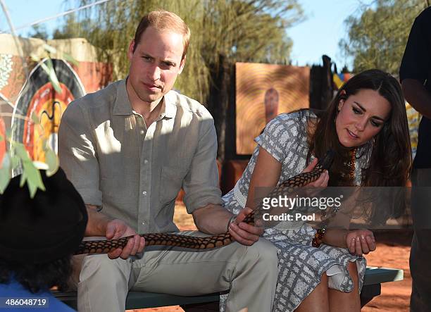 Prince William, Duke of Cambridge and his wife Catherine, Duchess of Cambridge inspect a snake made by Aboriginal elders during a visit to Uluru-Kata...
