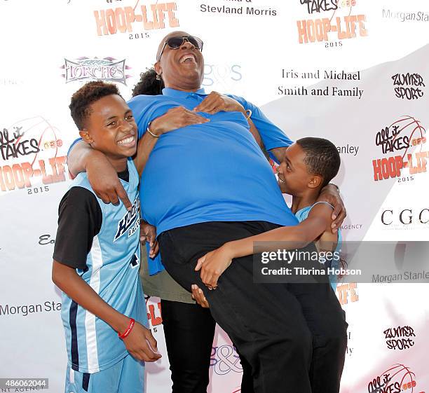 Kailand Morris, Kwame Morris and Mandla Morris lift their father, Stevie Wonder , on the red carpet at the 3rd annual Hoop-Life FriendRaiser at Galen...