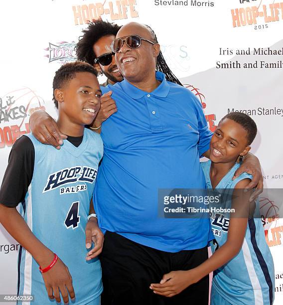 Stevie Wonder plays around with his sons Kailand Morris, Kwame Morris and Mandla Morris at the 3rd annual Hoop-Life FriendRaiser at Galen Center on...