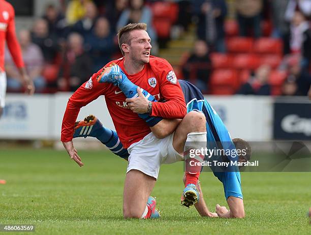 Liam Lawrence of Barnsley tangles with Michael Brown of Leeds United during the Sky Bet Championship match between Barnsley and Leeds United at...