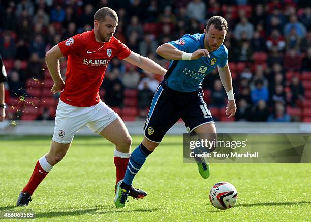 Stephen Dawson of Barnsley tackles Noel Hunt of Leeds United during the Sky Bet Championship match between Barnsley and Leeds United at Oakwell on...