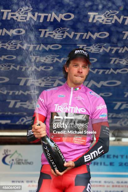 Daniel Oss of Italy and BMC Racing team celebrates claiming overall lead after his teams victory in the 13.4km team time trial from Riva del Garda to...