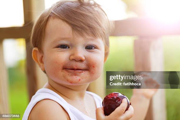 happy baby - plum stock pictures, royalty-free photos & images