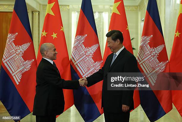 Chinese President Xi Jinping shankes hands with Cambodian King Norodom Sihamoni at the Great Hall of the People on August 31, 2015 in Beijing, China....