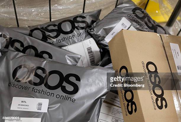 Completed customer orders sit in a trolley ahead of shipping at Asos Plc's distribution warehouse in Barnsley, U.K., on Tuesday, April 22, 2014....