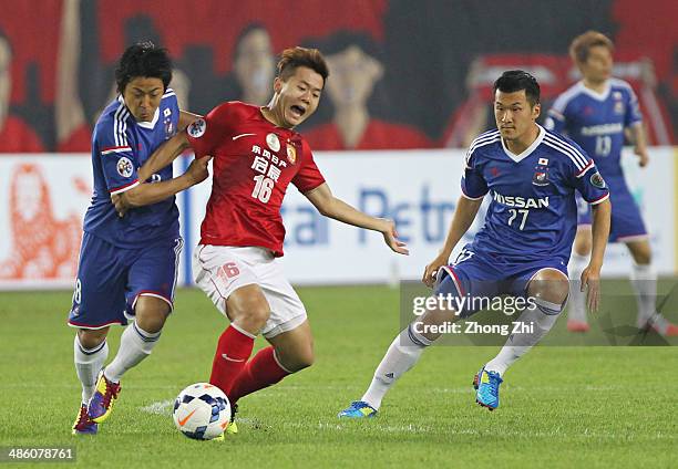 Nakamachi Kosuke and Tomisawa Seitaro of Yokohama F. Marinos compete the ball with Huang Bowen of Guangzhou Evergrande during the AFC Asian Champions...